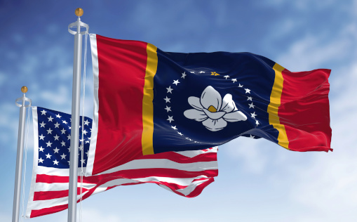 United States and Louisiana state flags on flagpoles